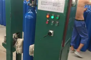 To screw a valve onto a gas cylinder